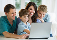 Family using a laptop to fill out a life insurance quote form